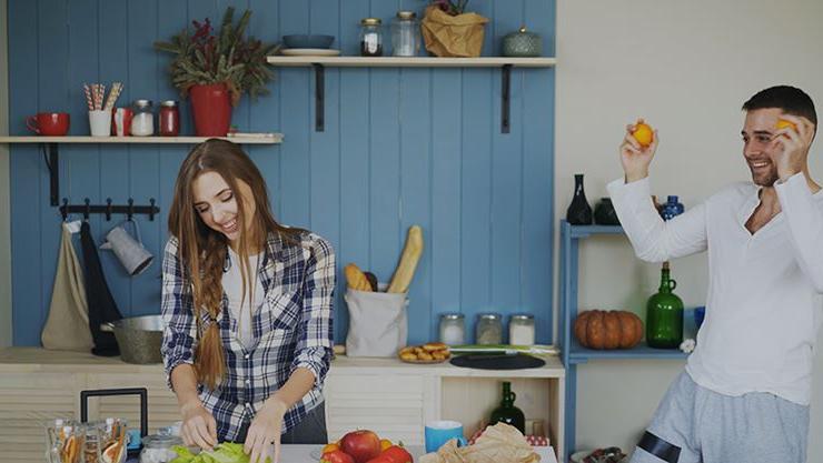 Couple preparing a meal in kitchen